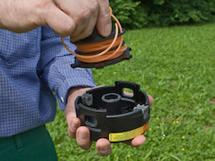 : Step 5 of 7: Inserting the spoolNow insert the spool into the top casing. Remove the ends of the lines from the openings in the spool and place them in the groove provided in the mowing head.