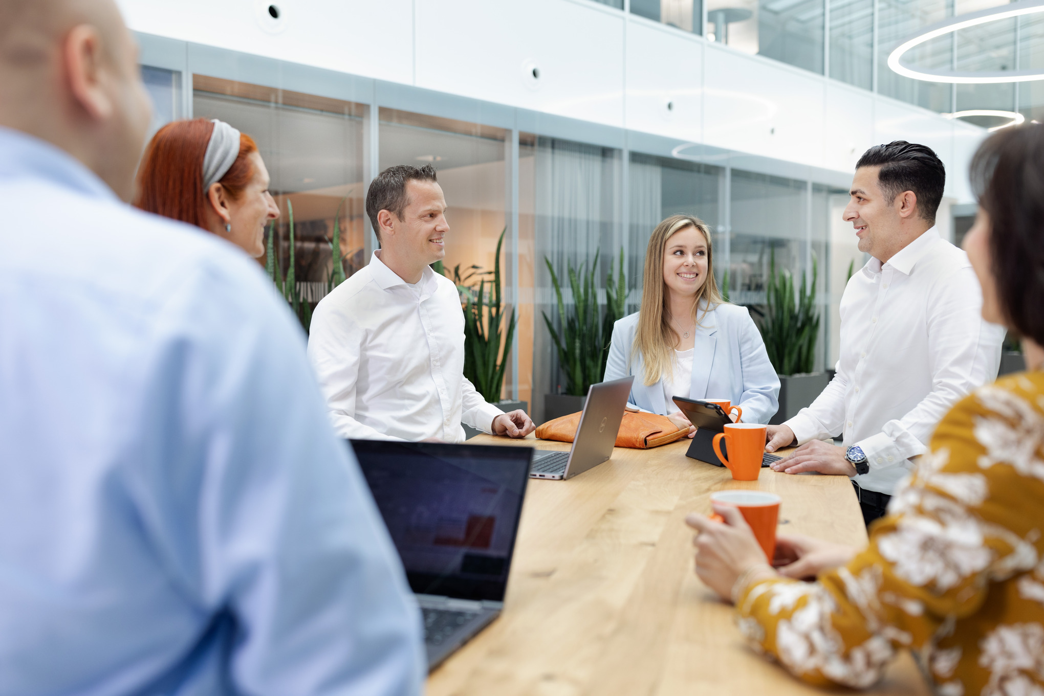 People around a desk with laptops