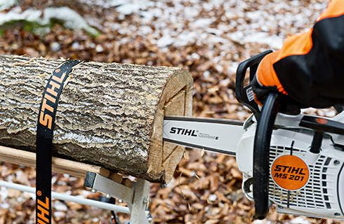 DIY log lantern: a square being cut into the end face of a lashed log with a STIHL MS 201 C-M petrol chainsaw with M-Tronic