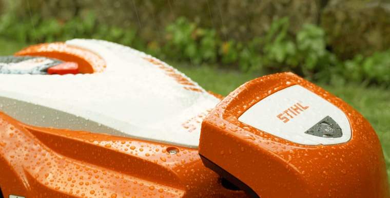 A STIHL iMOW® mower outside in the rain