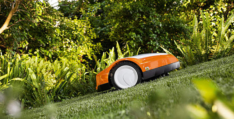 A STIHL iMOW® RMI 632 robot mower on a hilly lawn