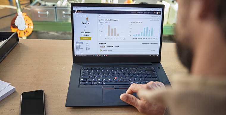 A person using the STIHL connected Portal on a laptop to view various power tool data.